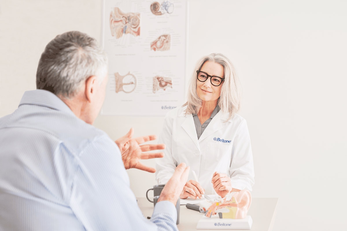 A Beltone Hearing Care Professional consulting with a senior about their hearing loss