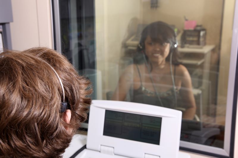 patient hearing test in sound booth