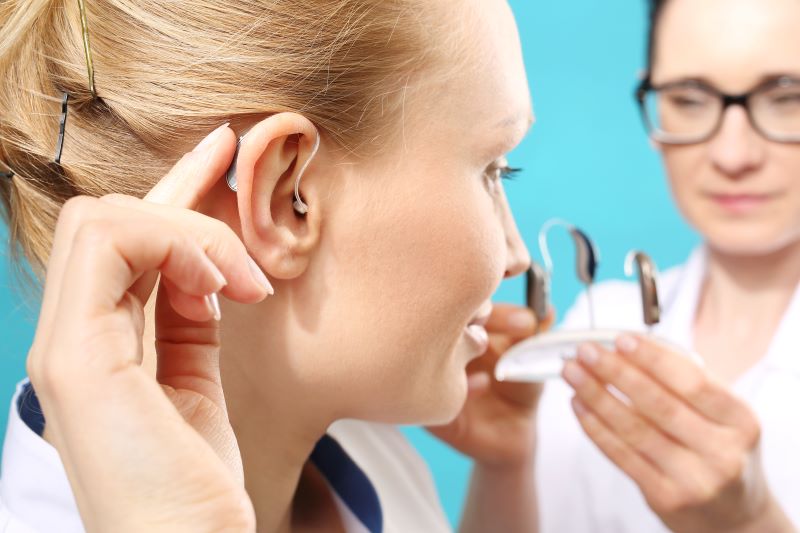 hearing aid provider and patient reviewing hearing aid styles