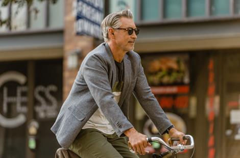 a person riding their bicycle while wearing Beltone hearing aids