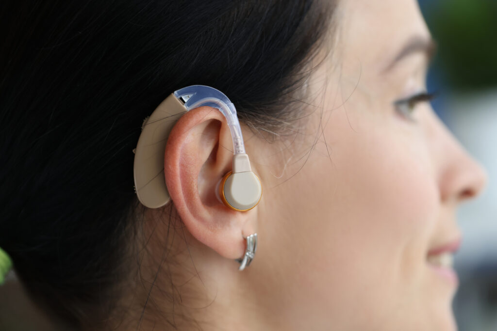 Behind the ear hearing aid on a womans ear closeup.
