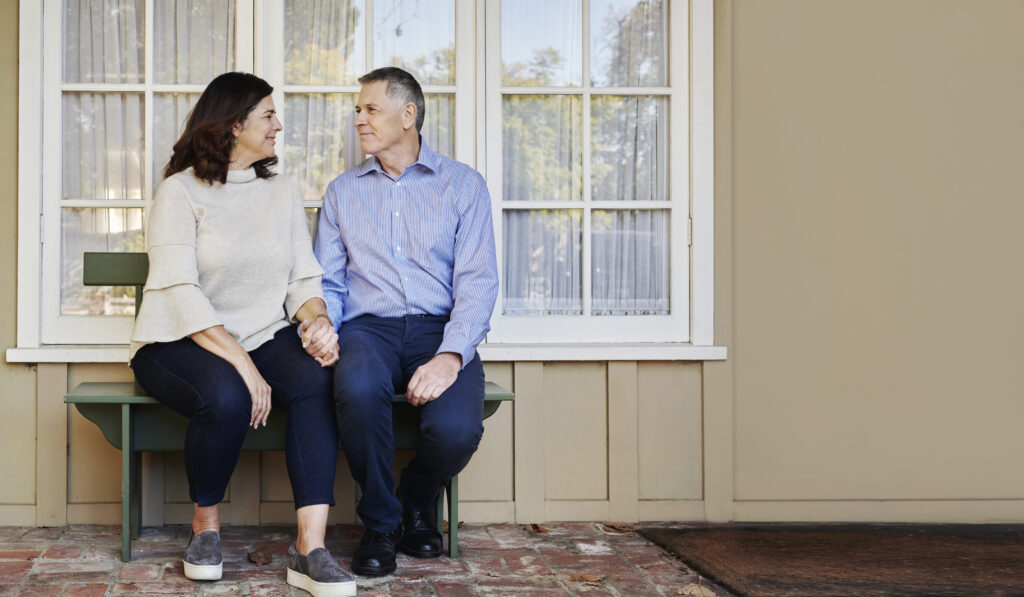 two people sitting on the bench with hearing aids